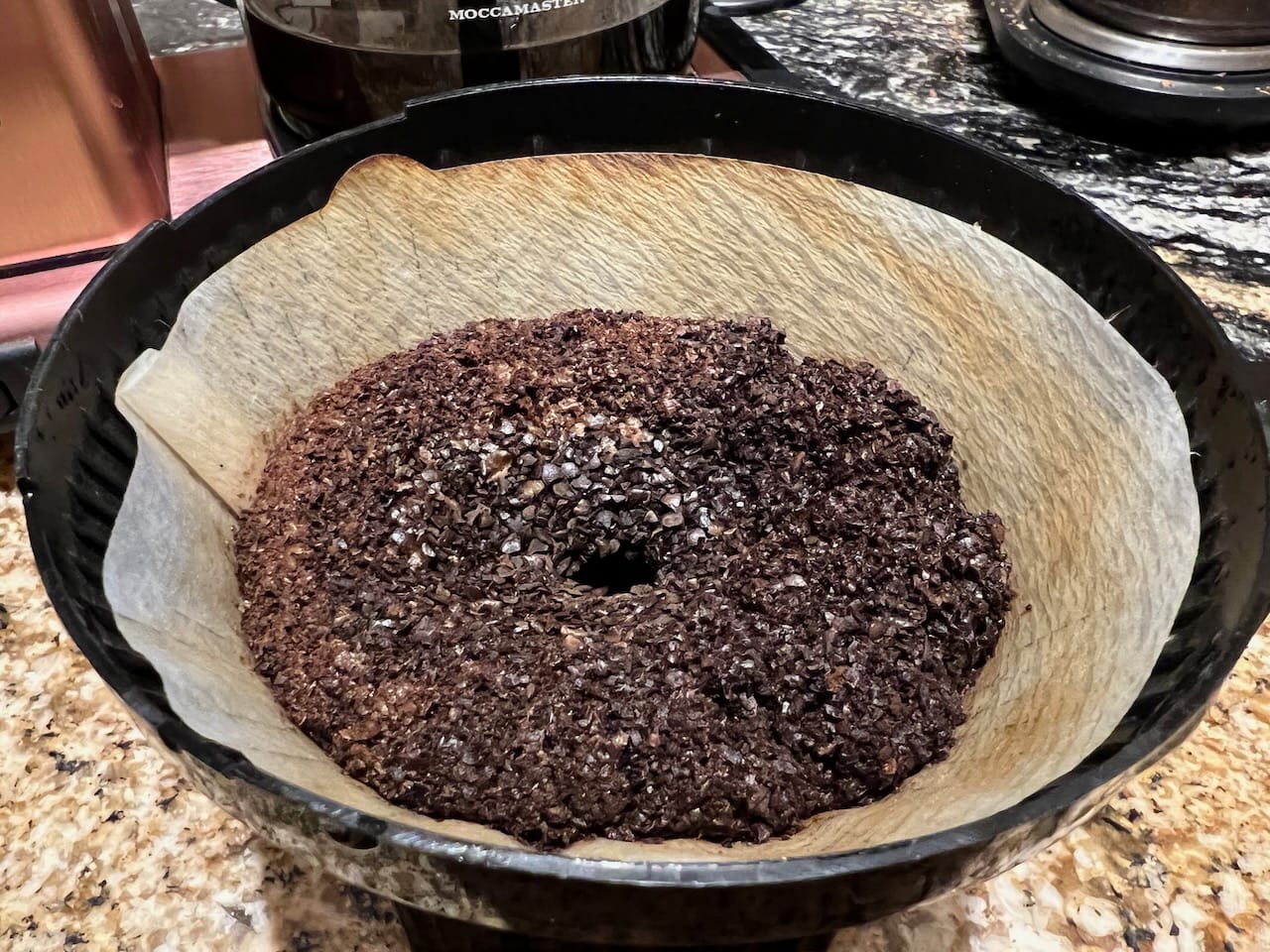 Even, saturated bed of coffee grounds on Moccamaster coffee maker.